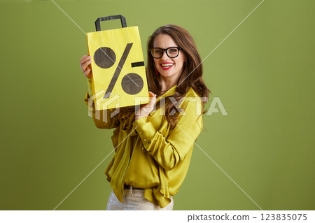 happy female in green blouse and glasses on green happy female in green blouse and glasses on green 123835075