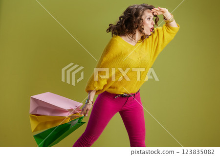 surprised fit woman against green background 123835082