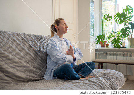 Serene woman with clasped hands, meditating in Yoga lotus Asana. Self reflection, deep breath 123835473