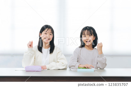 Two girls doing fist pump while studying 123835707