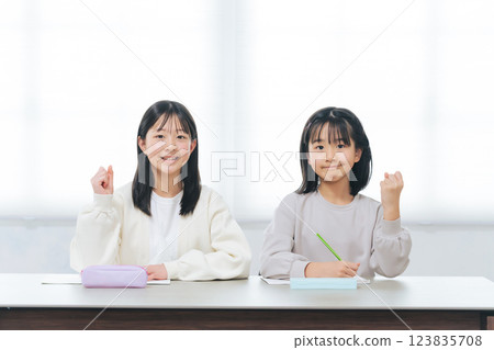 Two girls doing fist pump while studying 123835708
