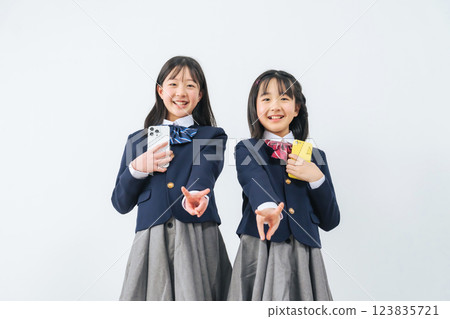 Group of female students making peace signs while holding smartphones Group of female students making peace signs while holding smartphones 123835721
