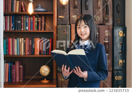 A female student reading a book in a stylish antique space 123835733