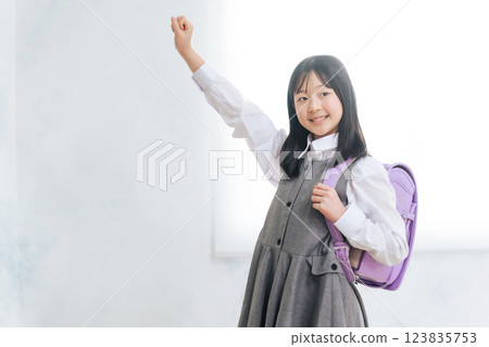 Girls carrying a school bag 123835753
