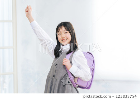 Girls carrying a school bag 123835754