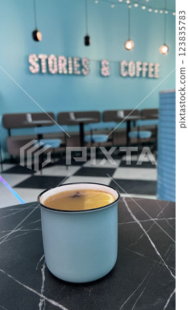 Mug of mulled wine in a cafe. Cafe. Vertical photo. Gently muted colors. 123835783
