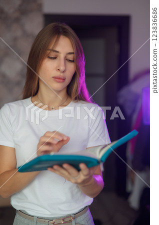 Bible, woman 20s study and writing, notes on religion at desk in home, Christian faith and knowledge of God. Reading, hope and girl holy book, learning gospel inspiration prayer in a white T-shirt Bible, woman 20s study and writing, notes on religion at desk in home, Christian faith and knowledge of God. Reading, hope and girl holy book, learning gospel inspiration prayer in a white T-shirt 123836686