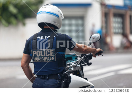 French municipal policeman on his motorbike French municipal policeman on his motorbike 123836988