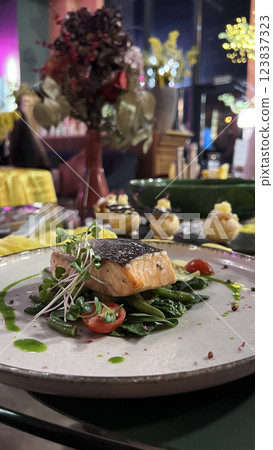 Baked salmon with asparagus. Dishes in a restaurant. Atmosphere of luxury. Dinner. Romance. 123837323