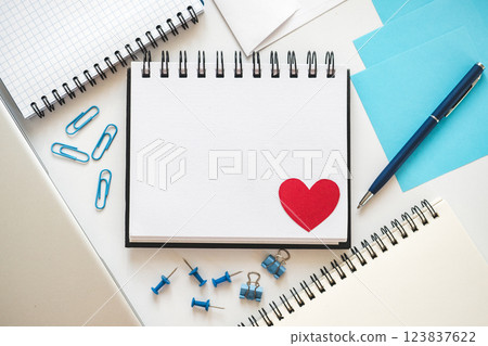Blank notepad page and red heart drawing 123837622