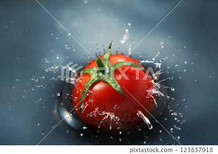 Cherry tomatoes falling into the water 123837918