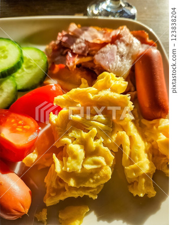 Scrambled Eggs, Crispy Bacon, Sausages, and Fresh Vegetables on White Plate. High quality photo Scrambled Eggs, Crispy Bacon, Sausages, and Fresh Vegetables on White Plate. High quality photo 123838204