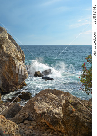 Waves of the Black Sea crash on a rocky shore on a sunny day in Crimea. Waves of the Black Sea crash on a rocky shore on a sunny day in Crimea. 123838443