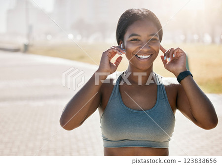 Happy black woman, city running and portrait of fitness, exercise and sports training at park in morning fog outdoors. Marathon runner listening to music for energy, workout and wellness motivation 123838656