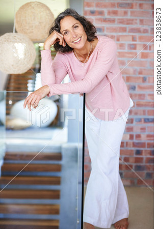 Glass railing, home and senior woman with portrait, fashion and casual outfit with happiness, smile and cheerful lady. Apartment, old person and pensioner in a lounge, leaning and brick wall with joy 123838673