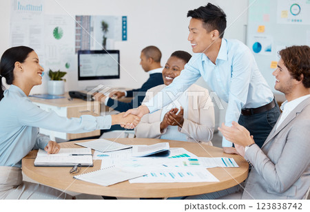 Success, handshake and applause from business people in a meeting for reaching sales targets, goals and winning a deal. Smile, diversity and happy marketing manager shaking hands with office worker 123838742