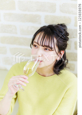 A young woman drinking wine 123838976