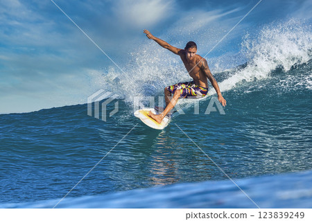 Male surfer on a blue wave Male surfer on a blue wave 123839249
