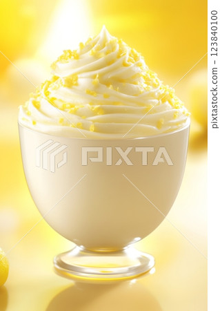 Creamy dessert topped with yellow sprinkles in bright setting 123840100