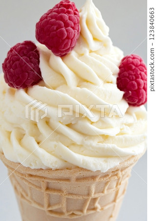 Raspberry ice cream cone with fresh berries 123840663