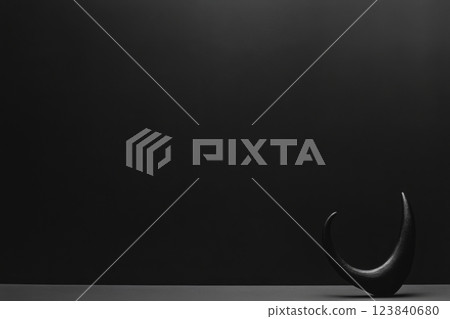 Dark abstract sculpture on black backdrop 123840680