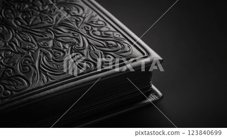 Black leather book with embossed floral design 123840699