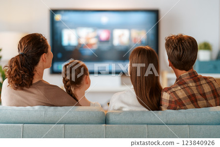 family watching  TV in the evening at home 123840926