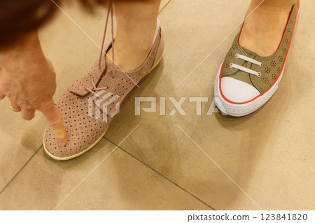Unrecognizable woman trying on shoes Unrecognizable woman trying on shoes 123841820
