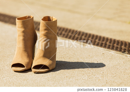 Brown boots with high heels and peep toes Brown boots with high heels and peep toes 123841828