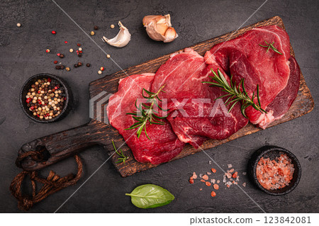 Raw organic steak with ingredients for cooking Raw organic steak with ingredients for cooking 123842081