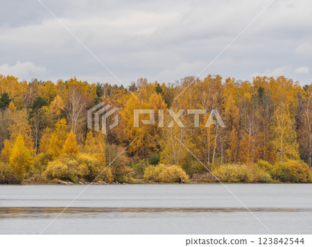 Autumn lake with trees on the shores. Reflection of blue sky with clouds in water. Autumn lake with trees on the shores. Reflection of blue sky with clouds in water. 123842544
