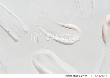 Smooth white cream smears on light background highlighting texture and skincare 123842864