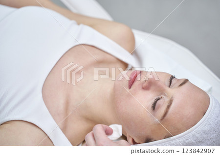 Female caucasian young adult relaxing during spa facial treatment Female caucasian young adult relaxing during spa facial treatment 123842907
