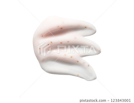 Smudge of white cream with exfoliating parts and light texture on white 123843001