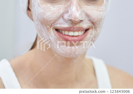Female caucasian young adult enjoying skincare routine with face mask at home Female caucasian young adult enjoying skincare routine with face mask at home 123843006