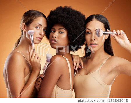 Makeup, beauty and women with brush for cosmetics against a brown mockup studio background. Portrait of young model group with cosmetic facial foundation and a luxury product for skin wellness 123843048