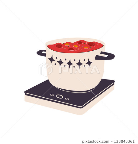 A pot of soup on an electric stove. 123843361