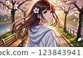 A girl looks back on a road lined with cherry blossoms 123843941