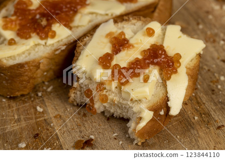 a soft loaf of wheat flour with butter and red salmon caviar a soft loaf of wheat flour with butter and red salmon caviar 123844110