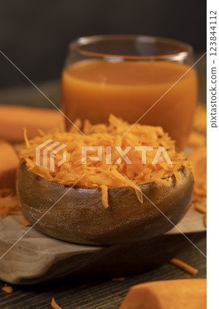 grated orange carrots and fresh carrot juice grated orange carrots and fresh carrot juice 123844112