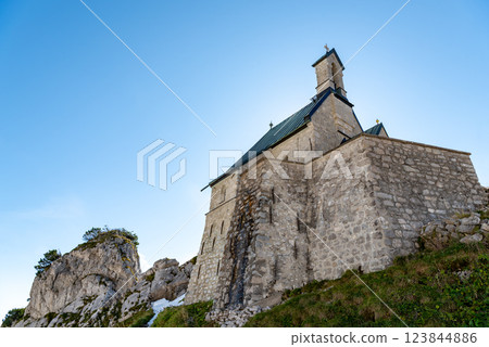 Stone church on a mountaintop in the Bavarian Alps on a sunny day in summer Stone church on a mountaintop in the Bavarian Alps on a sunny day in summer 123844886