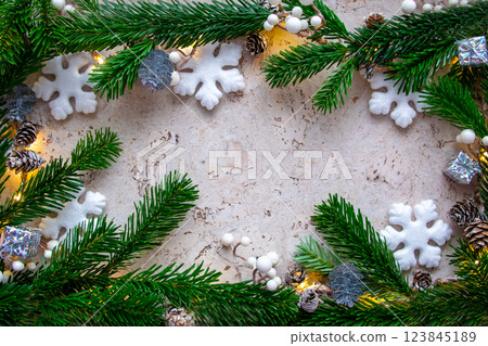 Christmas tree spruce for frame with light, gifts, snowflake and decor on the wood background in winter day. Copy space. Top view. Christmas tree spruce for frame with light, gifts, snowflake and decor on the wood background in winter day. Copy space. Top view. 123845189