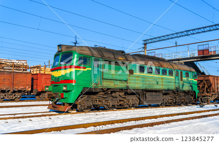 Diesel locomotive with a heavy freight train in winter in Korosten, Zhytomyr Oblast of Ukraine 123845277