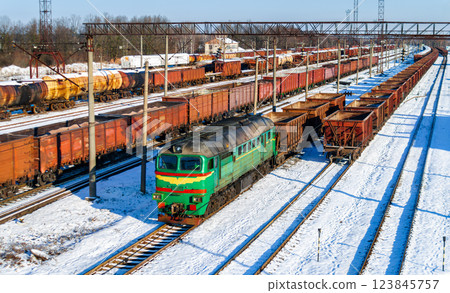 Diesel locomotive with a heavy freight train in winter in Korosten, Zhytomyr Oblast of Ukraine Diesel locomotive with a heavy freight train in winter in Korosten, Zhytomyr Oblast of Ukraine 123845757
