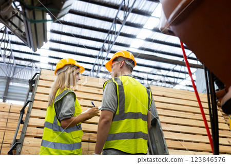 person worker holding clipboard take note report in lumber warehouse during workingtime. 123846576