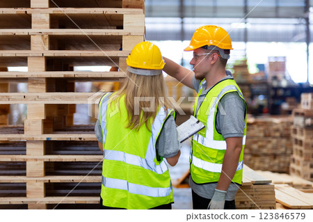 person worker holding clipboard take note report in lumber warehouse during workingtime. person worker holding clipboard take note report in lumber warehouse during workingtime. 123846579
