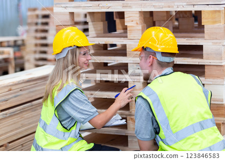 person worker holding clipboard take note report in lumber warehouse during workingtime. 123846583