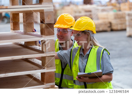 person worker holding clipboard take note report in lumber warehouse during workingtime. person worker holding clipboard take note report in lumber warehouse during workingtime. 123846584