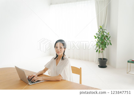 A woman using a computer 123847751