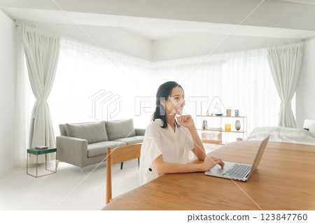 A woman using a computer A woman using a computer 123847760